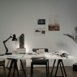 Minimalist architecture office with modern decor, white desk, and stylish layout.