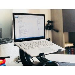 A home office setup featuring a laptop on a stand and a monitor, ideal for remote work.
